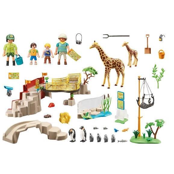 this picture shows everything in the box, the zookeeper, family, map, camera, giraffes, penguines, fedding supplies for the animals, and the enclosure to make a wonderful zoo. 