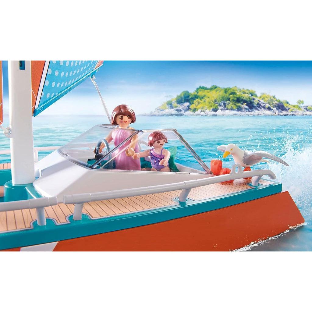 A closeup on the boat and family with a water background. The seafull is perched on the boat, the mom is steering. 