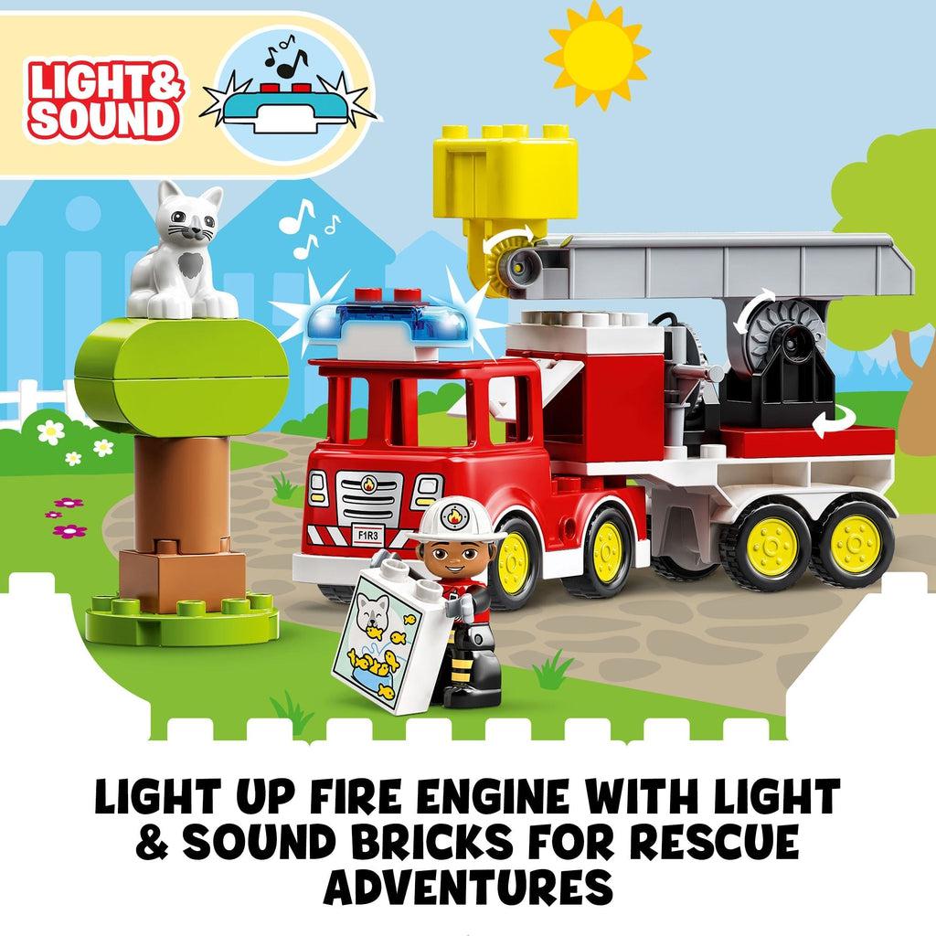 firefighter holding lego duplo bag of cat food in front of the truck and the tree with the cat in it | text reads: Light up fire engine with light and sound bricks for rescue adventures