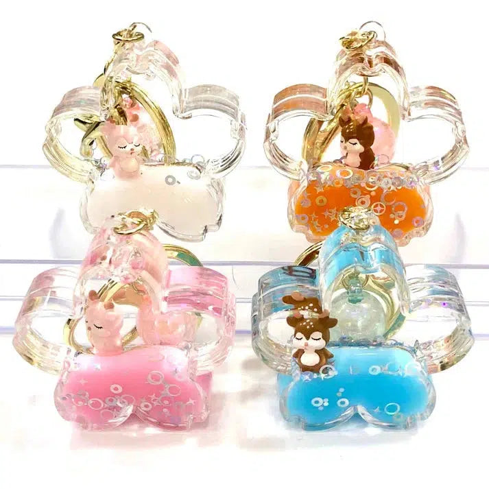 Four transparent keychains, each shaped like a star and featuring small animal figurines as key charms. These assorted styles boast different background colors: white, orange, pink, and blue. Perfect for adding a touch of whimsy to your collection.