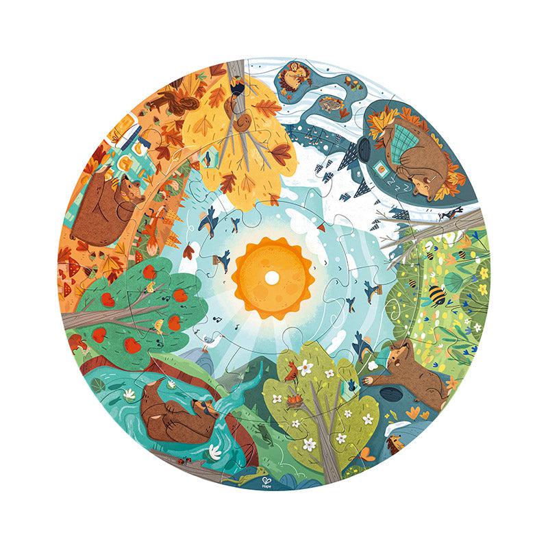 Image of the circular four seasons puzzle. It shows each of the four different seasons in the forest with bears doing activities that correspond with the season they're in.