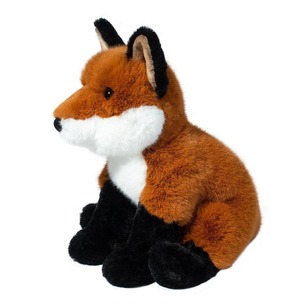 This image shows the fox from a front angle. the fox is incredibly fluffy and has adorable black paws that look like socks. 