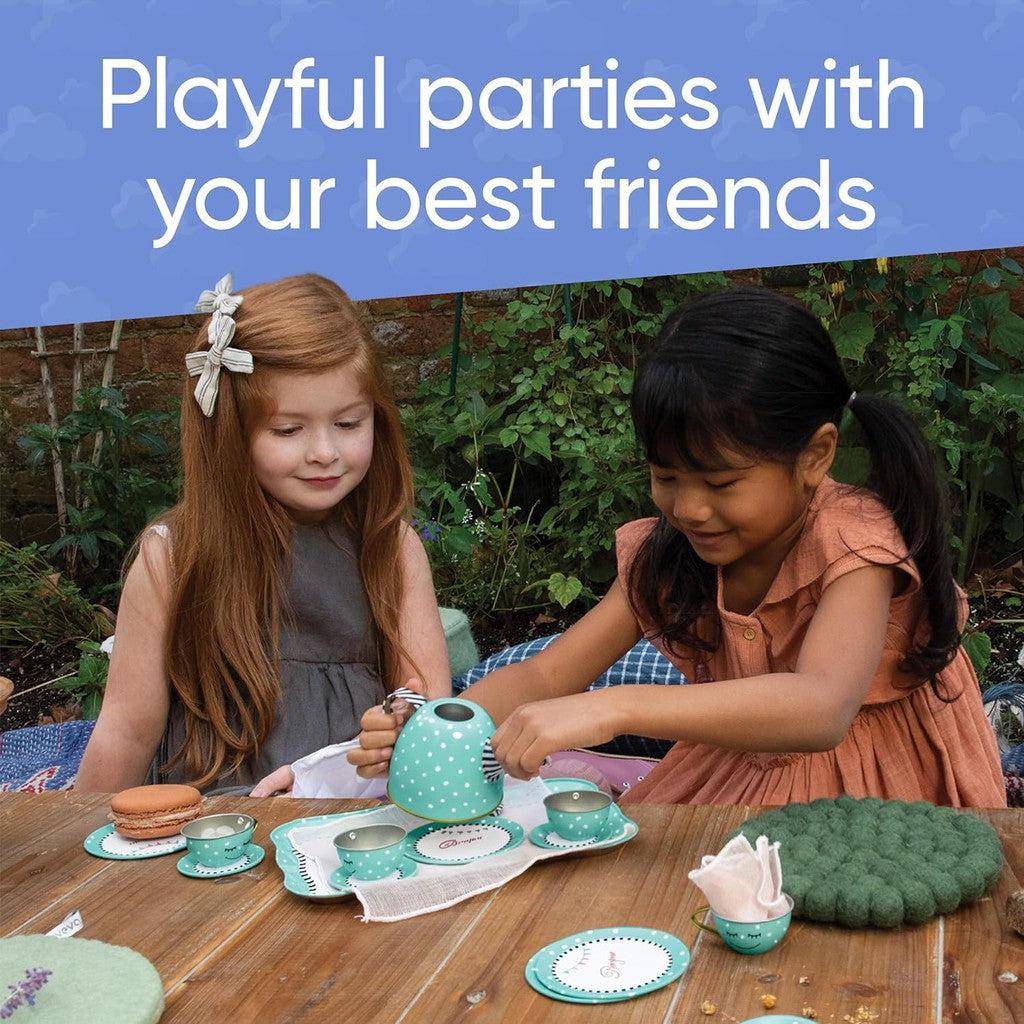 This image shows two girls hosting a tea party and having fun in a back yard. Text above them reads "p;ayful parties with your best friends"