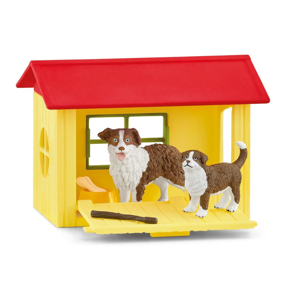 Image of the play set outside of the packaging. It comes with a red and yellow dog house, a parent dog, a baby dog, and some dog toys.