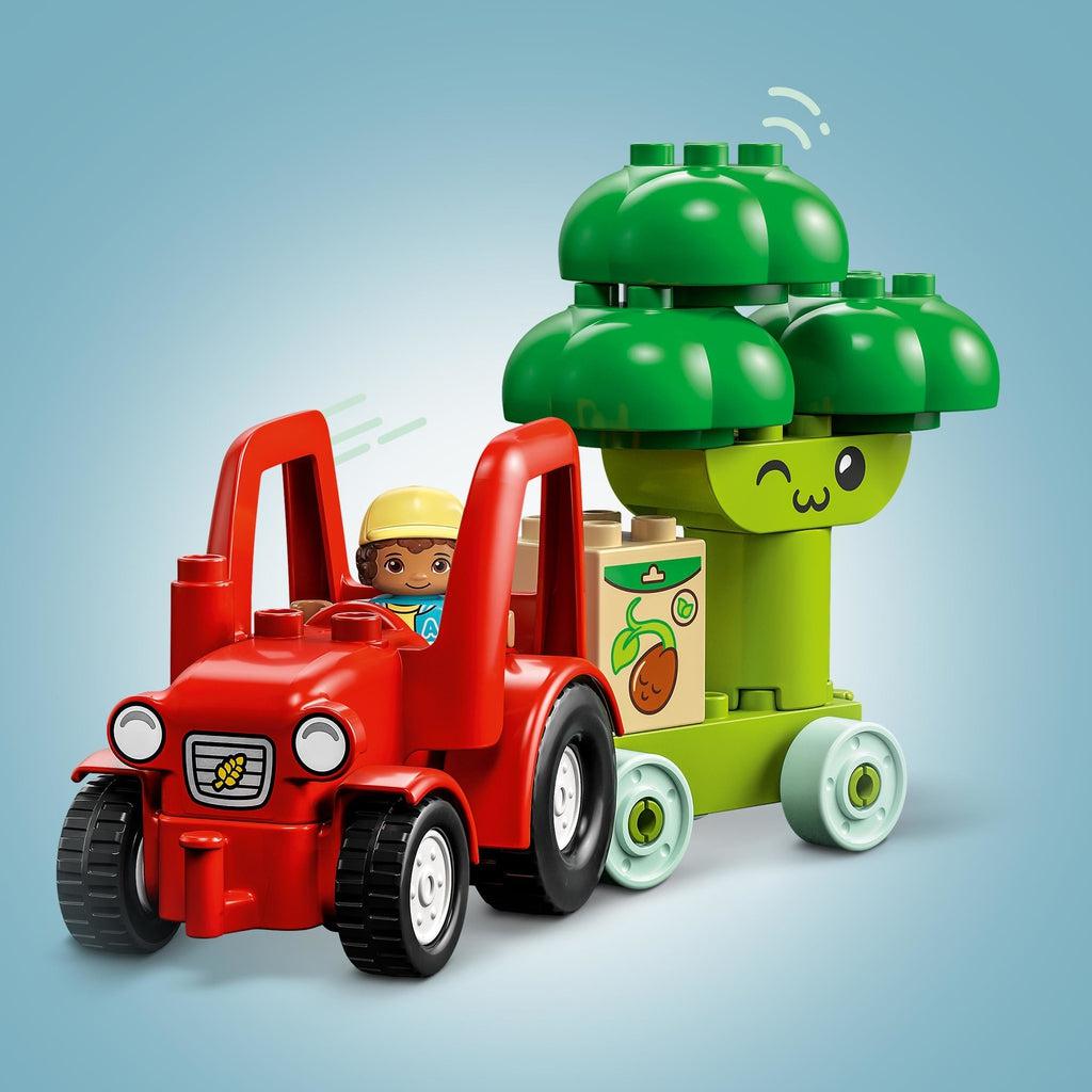 Close up of the included Duplo minifigure driving the tractor to pull the broccoli car and the fertilizer.