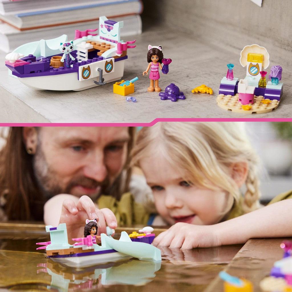 image shows a father and daughter playing with the Gabby Dollhouse. There are characters like an octopus to play with too!