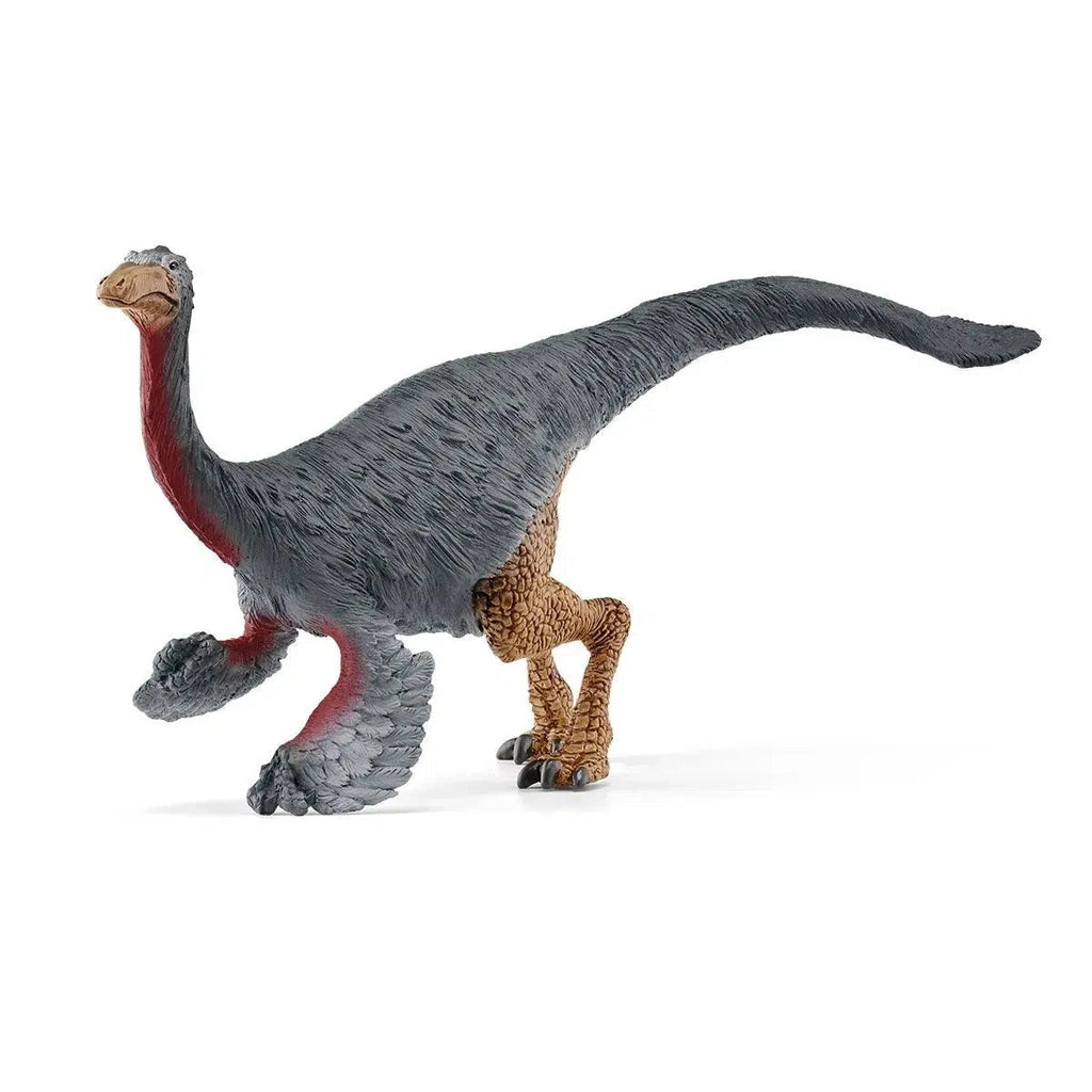 Image of the Gallimimus figurine. It is a grey bird-looking dinosaur with a red neck and belly. It has wings and chicken legs.