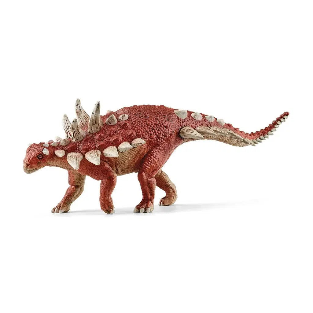 Image of the Gastonia figurine. It is a red dinosaur with lots of long white spikes coming out of its back and tail.