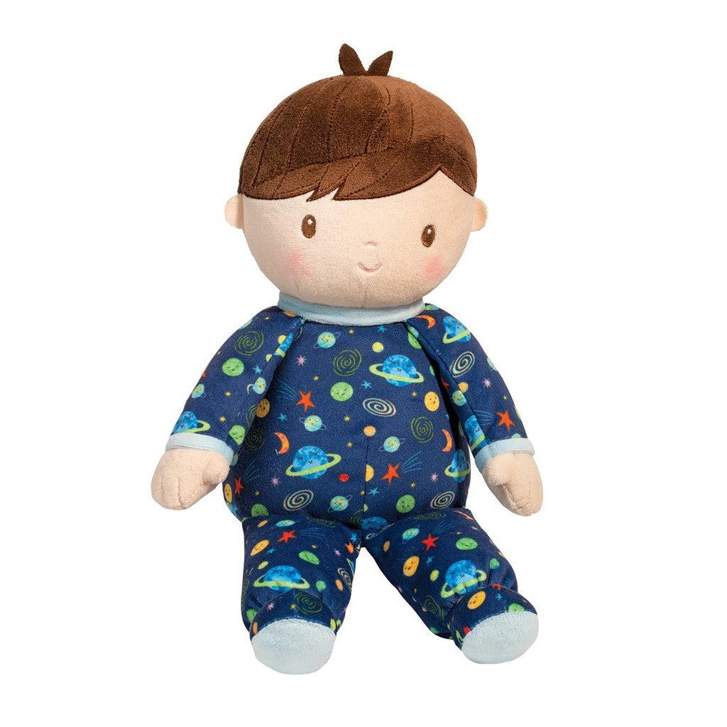this image shows a boy doll wearing blue pajamas that have pictures of planets and stars from outer space.