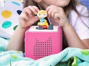 Girl playing with a Toniebox