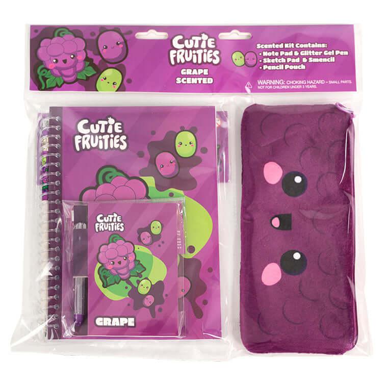 Image of the Grape Cuite Fruities Stationary Kit. It includes a grape themed notepad, glitter pen, sketch pad, smencil, and pencil pouch. Each grape face has little pink blushies under their eyes.