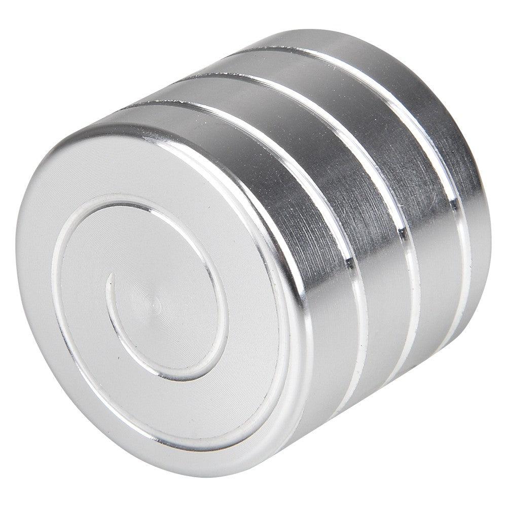 image shows the top of a Silver cylinder with a screw pattern that can spin and make the pattern swirl around.