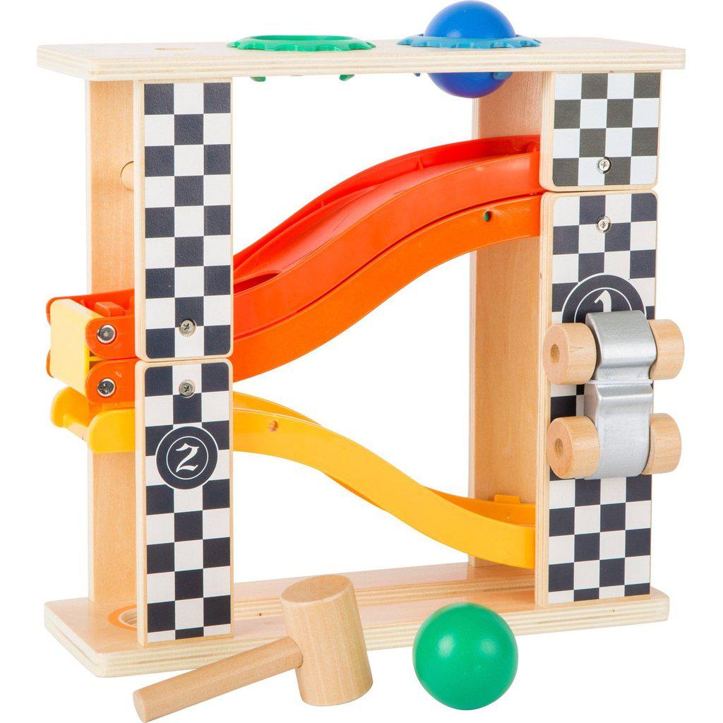 Image of the toy in the Hammer Marble Run mode. On the top are two holes for the balls (one green one blue) to rest in until you hammer them out of the hold so they roll down to the bottom. This makes the toy 2 layers tall.