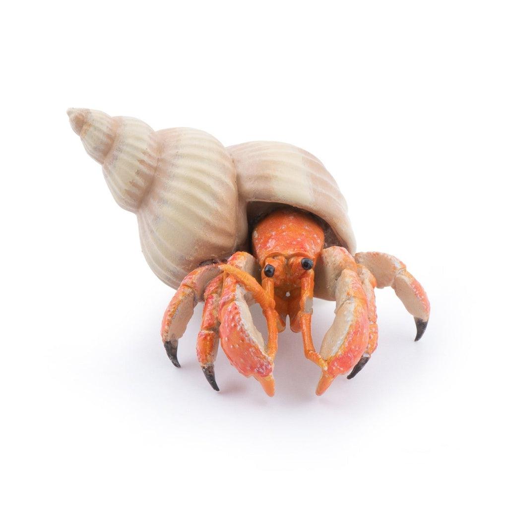 Image of the Hermit Crab figurine. It is an orange crab with a white spiral shell on its back.