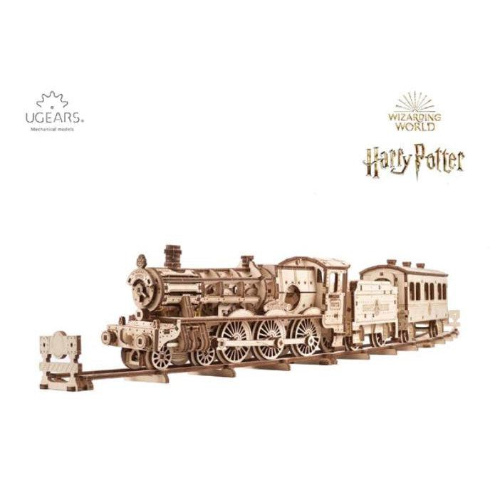 Image of the Hogwarts Express model. It is made from unpainted wood. It comes with the locomotive engine, a fuel car, and a passenger car as well as part of a track for these train cars  to rest on.