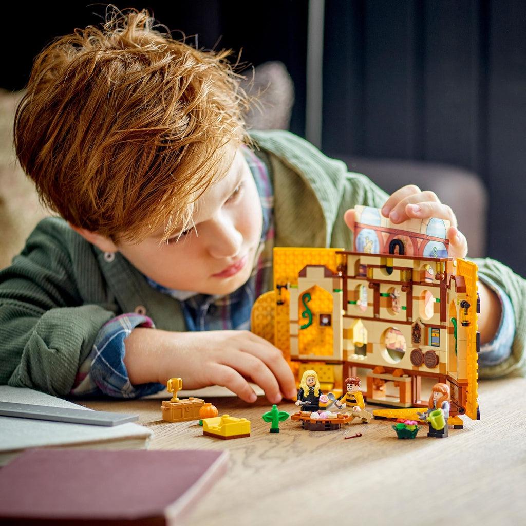 Scene of a boy building the LEGO playset.