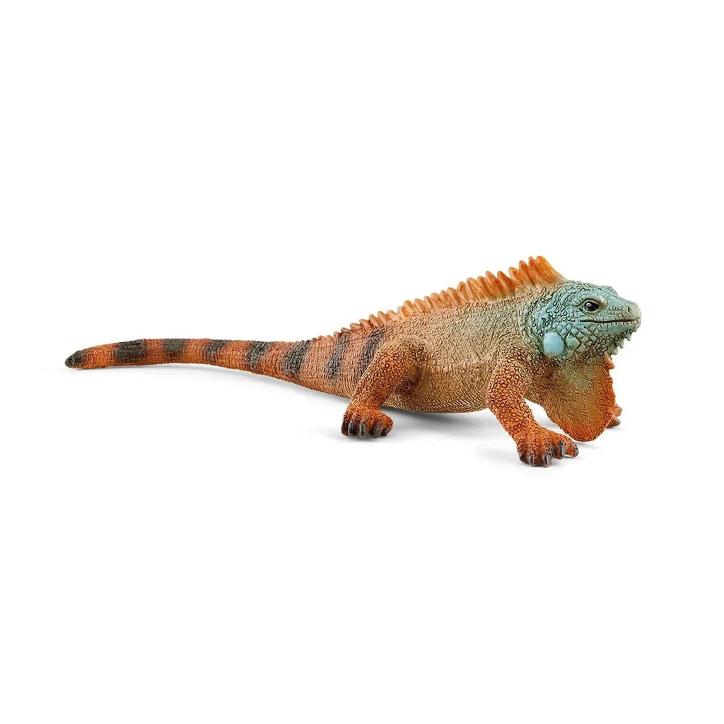 Image of the Iguana figurine. It is a green headed, orange bodies animal with black stripes on its tail and a large chin fin.