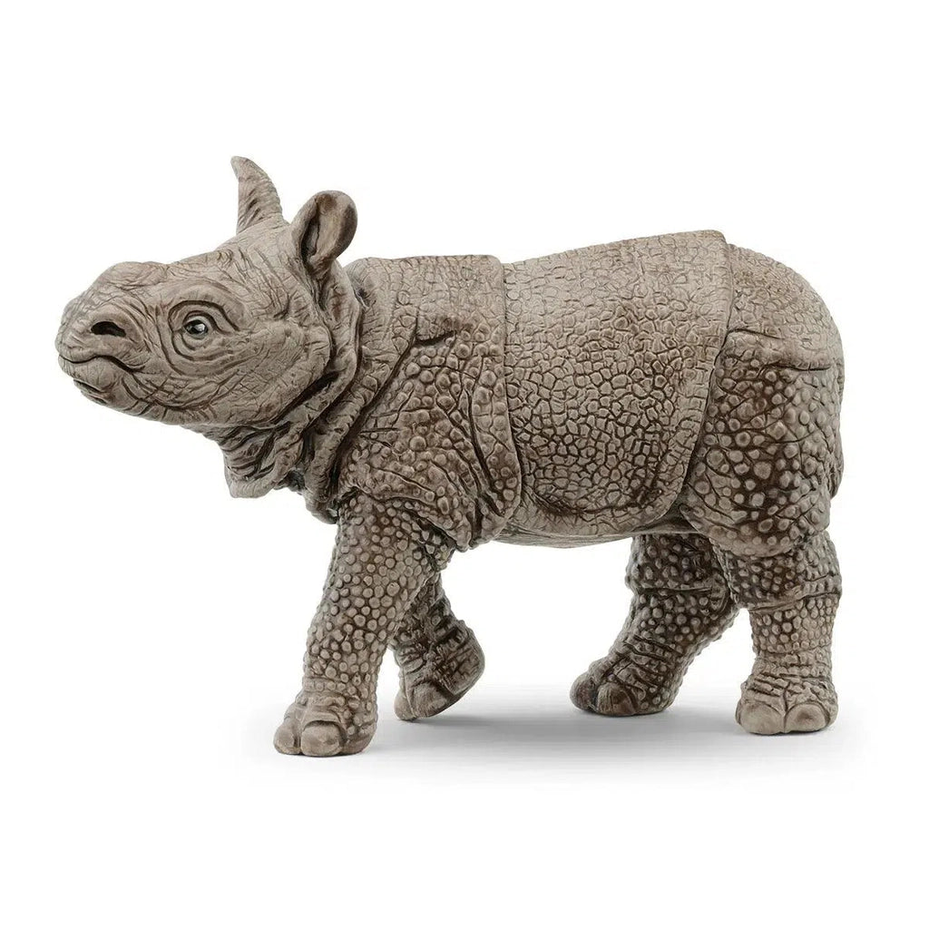 Image of the Indian Rhinoceros Baby figurine. It is a grey rhino with lots of crackles in its skin. It is shaped so that it looks like it is armored.