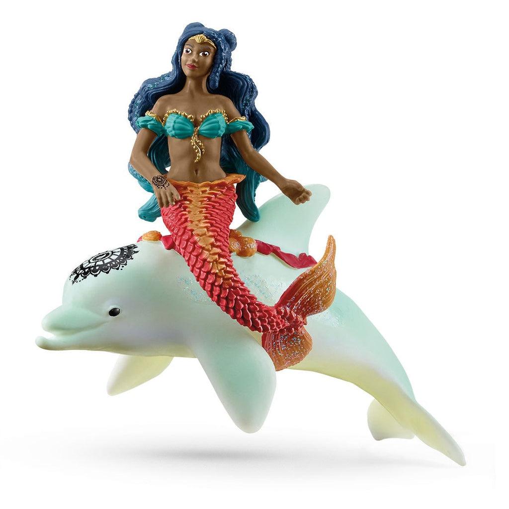 Image of the Isabelle on Dolphin figurine. It is a dark skinned mermaid with long black hair with a red mermaid tail. She is riding a white dolphin.
