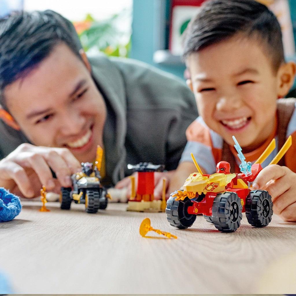 image shows a father and son playing with the LEGO Ninjago car and bike set