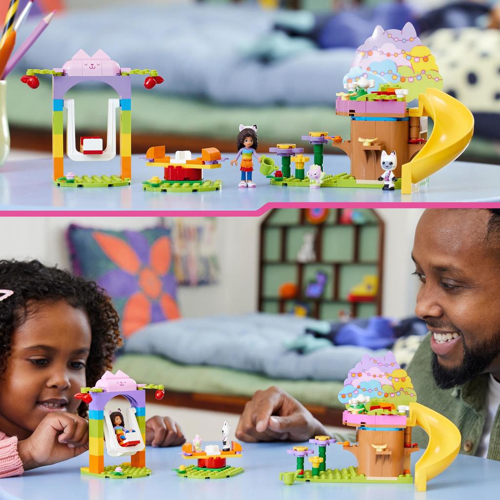 Image shows a father and daughter building and playing with the LEGO kitty fairy's garden party