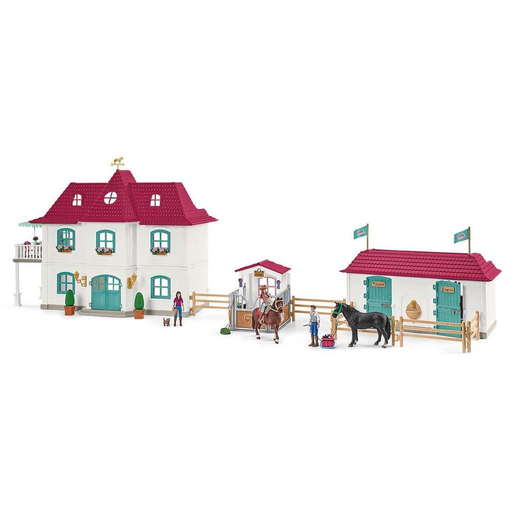 Image of the play set outside of the packaging. It comes with a manor house, a stables, and a horse stall as well as many different people figures and horses.