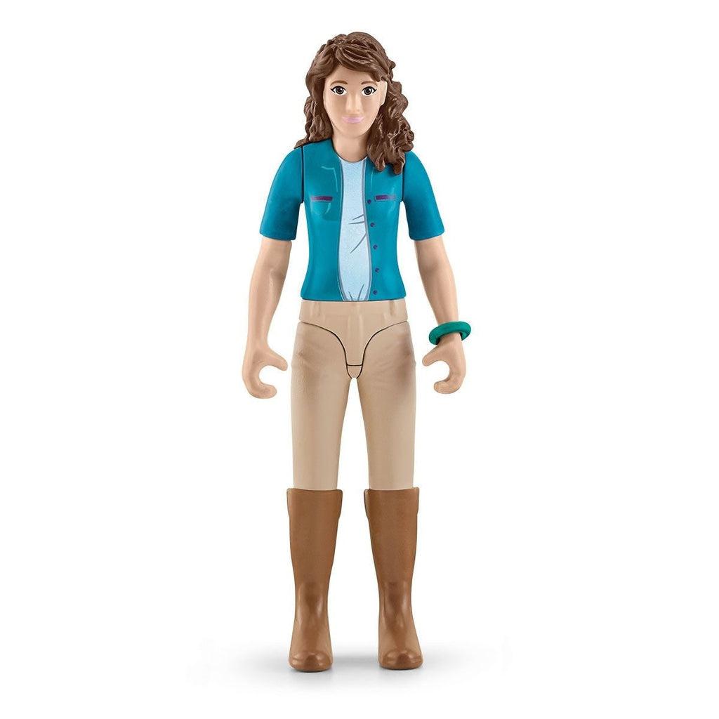 Close up of one of the figures. She has curly dark brown hair with a blue jacket, tan pants, and brown boots.