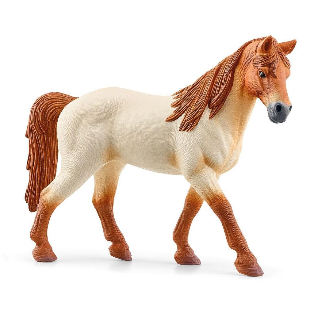 Close up of one of the included horse figures. It is a light horse with a brown head, legs, and mane and tail.
