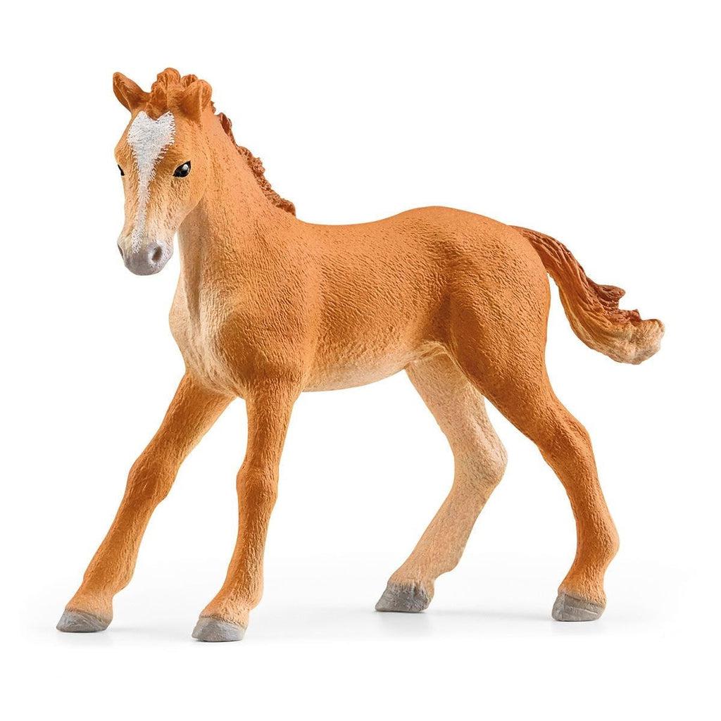 Close up of the smaller horse figure. It is an orange brown horse with a white stripe on its head.
