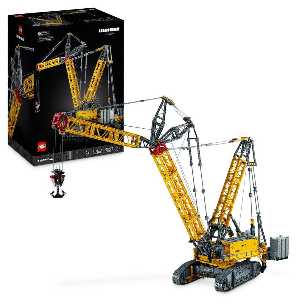 image shows the Liebherr Crawler Crane in the box and constructed. Its a large yellow crane made out of LEGO