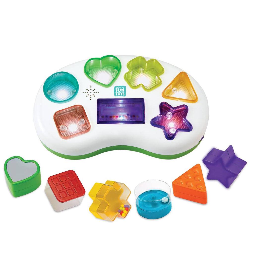 Image of the toy outside of the packaging. It has a base with differently shaped and colored indents that light up. Whenever you place the corresponding spot, it will make a sound. 