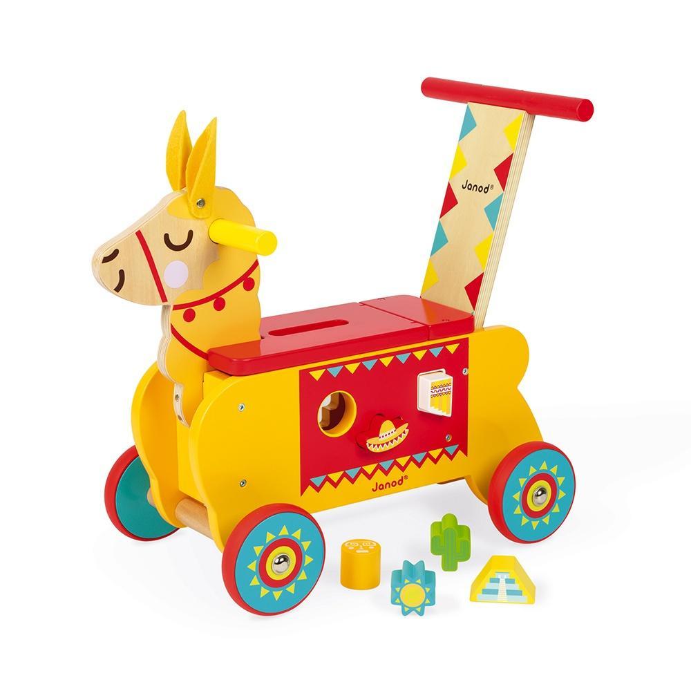 Image of the toy outside of the packaging. The llama is mainly yellow with red accents and it has a smile. On each side are shaped holes where you can sort the wooden blocks. All the blocks are Mexico themed with pictures of sombreros, Mexican ruins, and an outline of New Mexico.