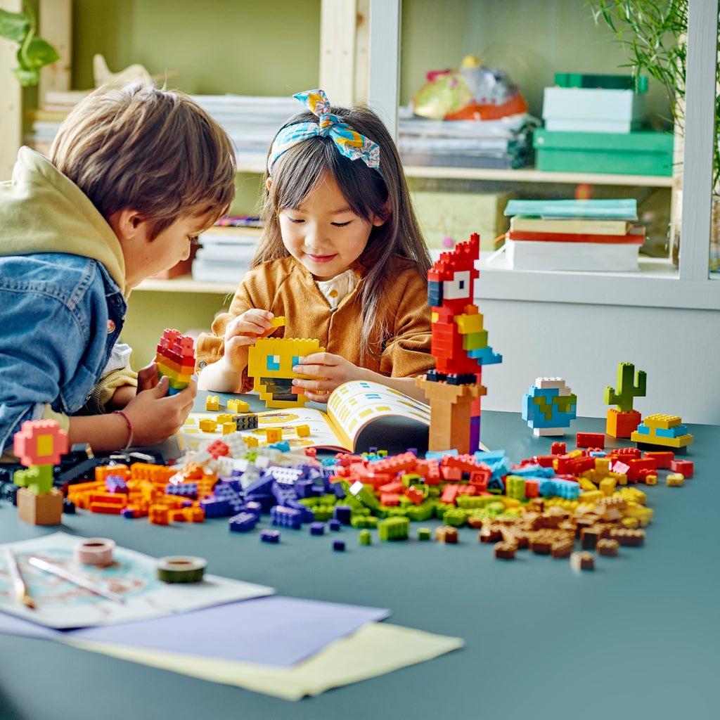 Scene of a little boy and girl creating fun builds with the LEGO creativity kit.