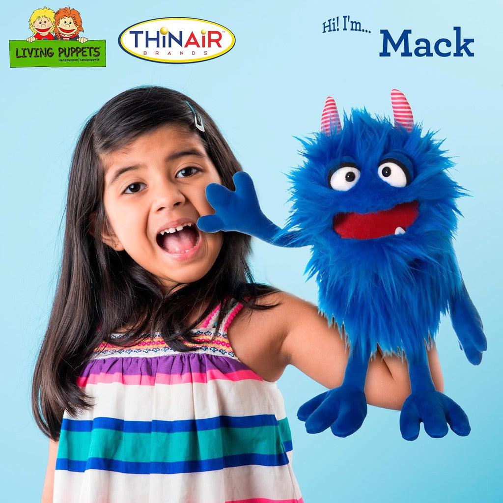 this image shows the mack monster being held by a child as she manuvers the puppet! "Hi i'm mack!