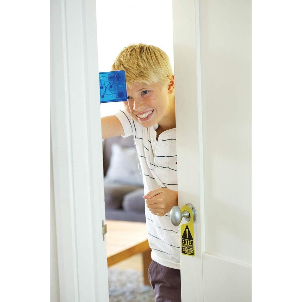 Scene of a young boy installing the intruder alarm on his door.