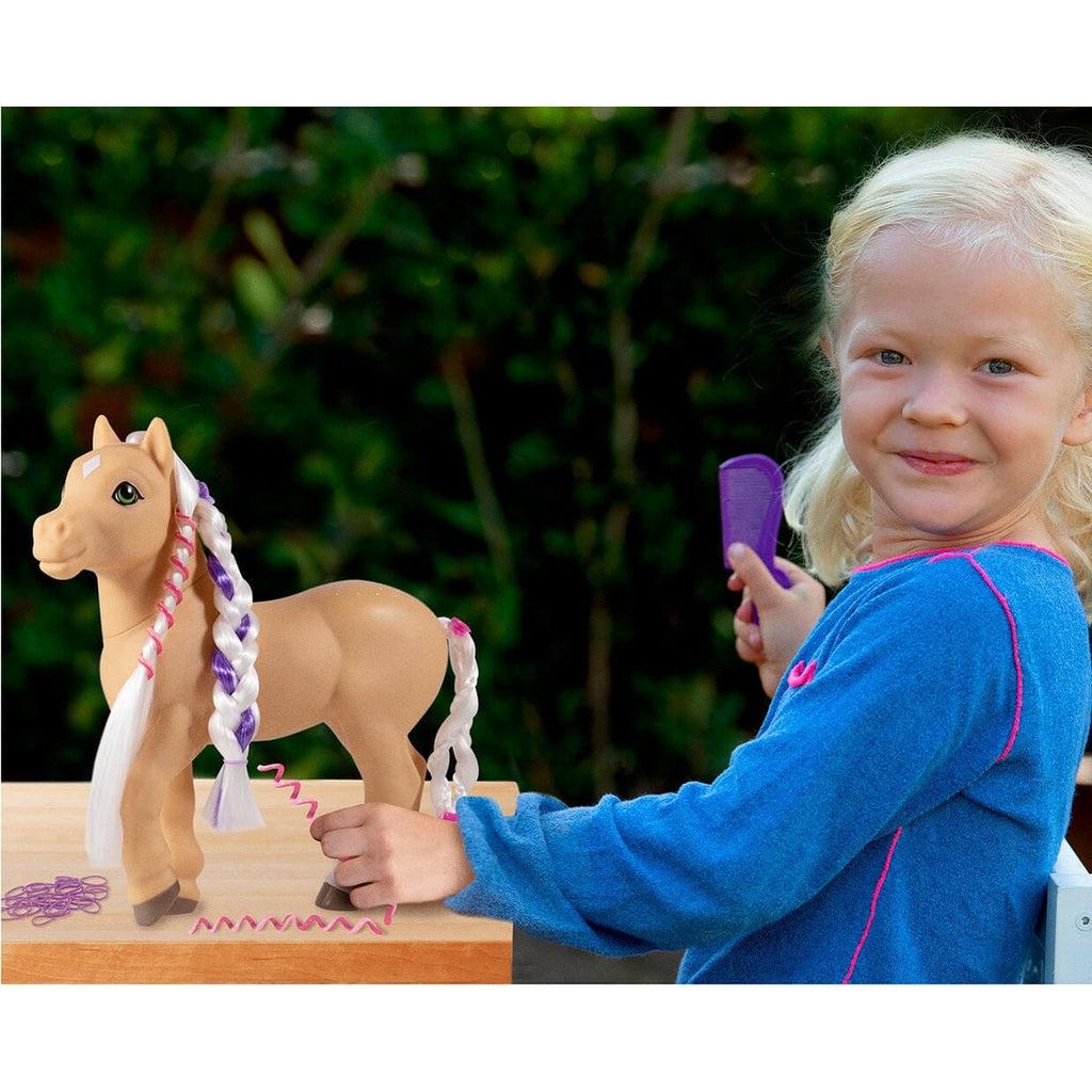 Scene of a little girl playing with the horse figurine.