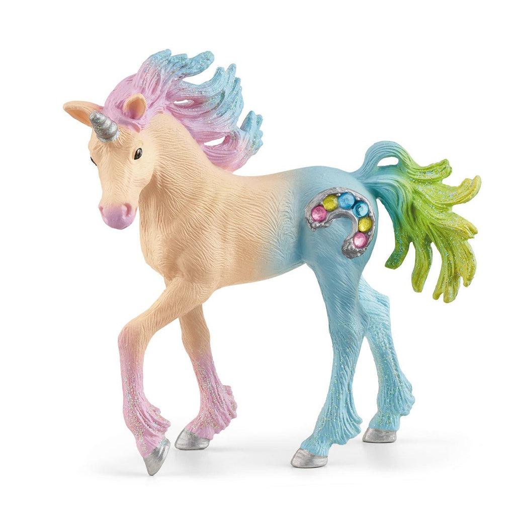 Image of the Marshmallow Unicorn Foal figurine. It is a multicolored pastel unicorn with a silver horn and a silver rainbow cutie mark with colorful gems imbedded in it. The unicorn's colors go from orange to pink to blue to green.