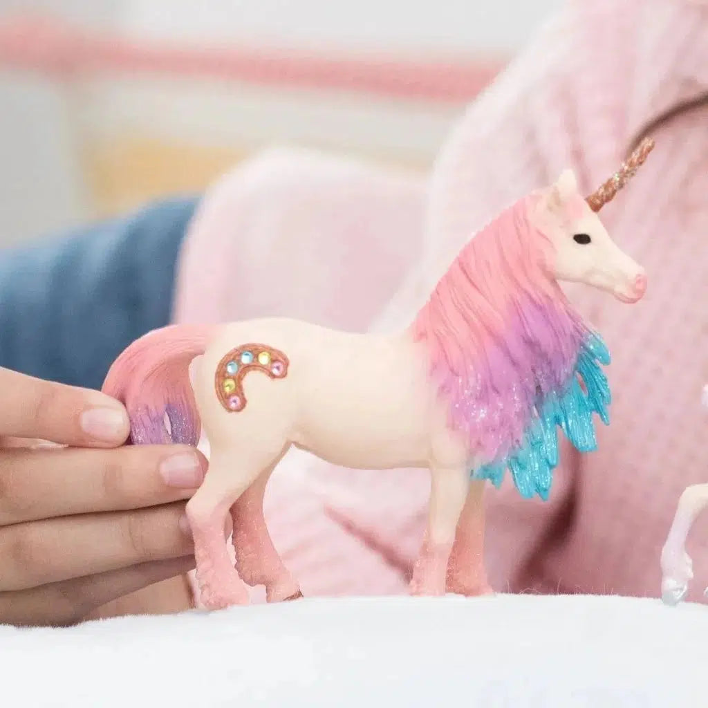 Scene of a girl playing with the unicorn toy.