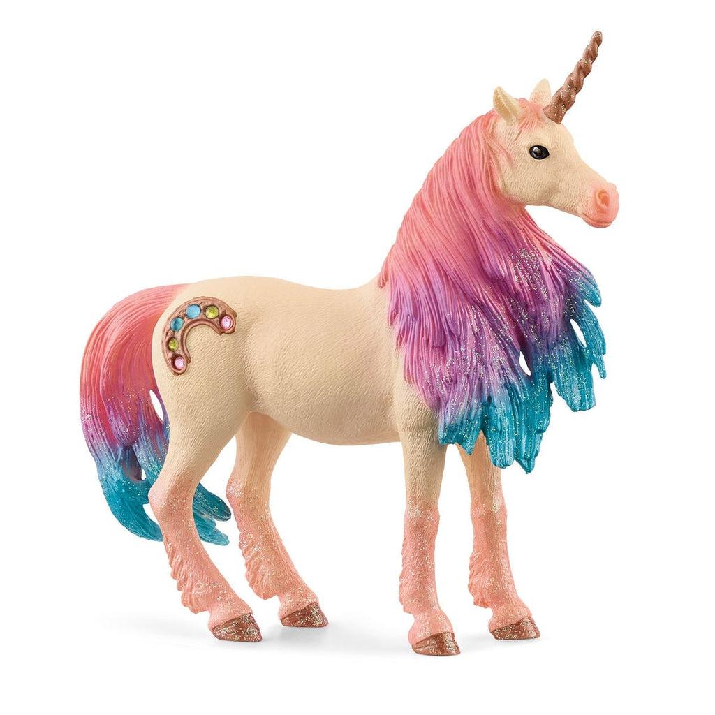 Image of the Marshmallow Unicorn Mare figurine. The unicorn has a tan and pink body with a rainbow cutie mark made of rhinestones. The unicorn's hone and hooves are a sparkly brass color. The mane and tail are multiple colors with pink starting at the hair's root and transferring to purple and then to blue.