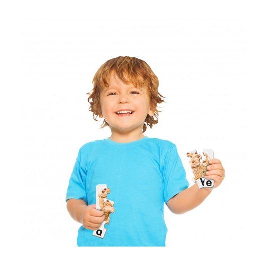 Scene of a little boy holding some of the game pieces and smiling.