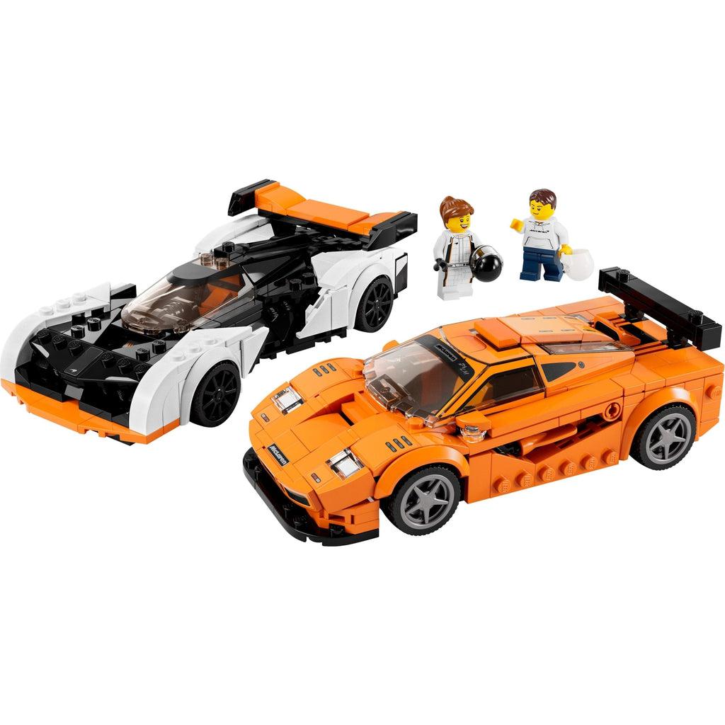 the two included minifigures shown standing behind the race cars