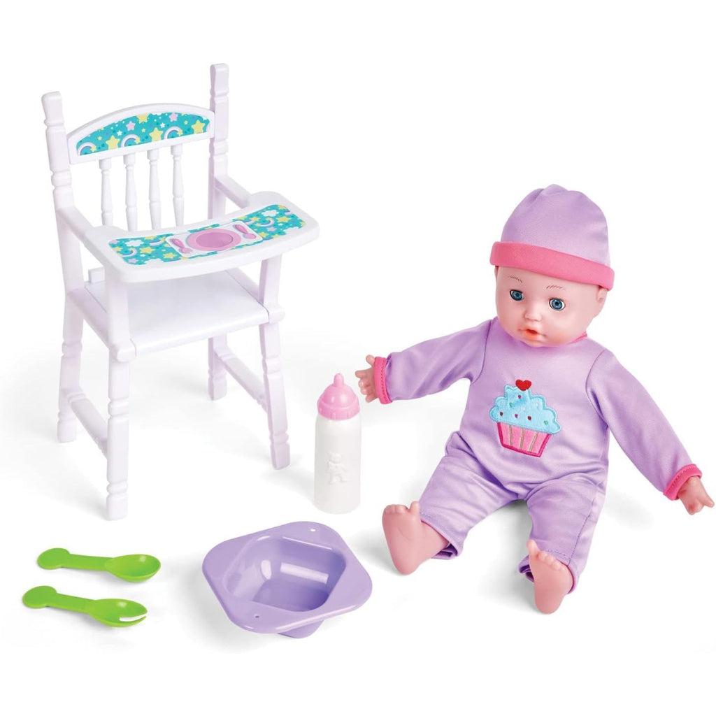 image of the baby sitting on the ground, showing off the high chair, the bottle, spoons and bowl used as accessories for feeding the doll. 