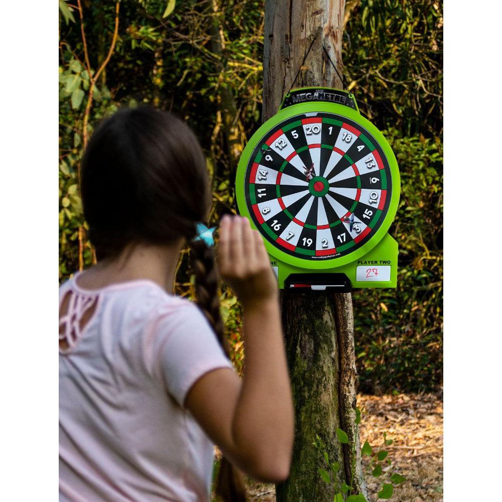 Scene of a girl playing with the dart board outside.