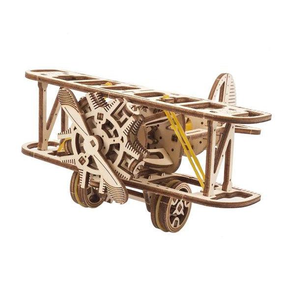 Image of the Mini Biplane model. It is an unpainted wooden old-fashioned plant complete with a propeller, wheels, and rubber bands.
