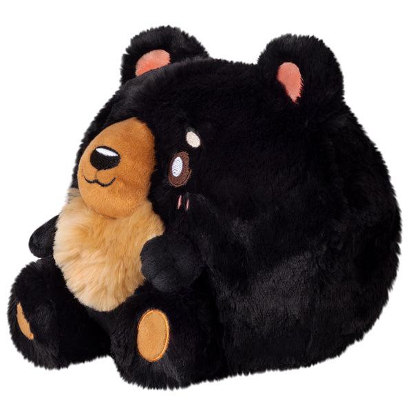 Side view of the plush. Shows that the plush is generally circle shaped.