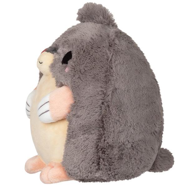 Side view of the plush. Shows that it has a tiny tail in the back.