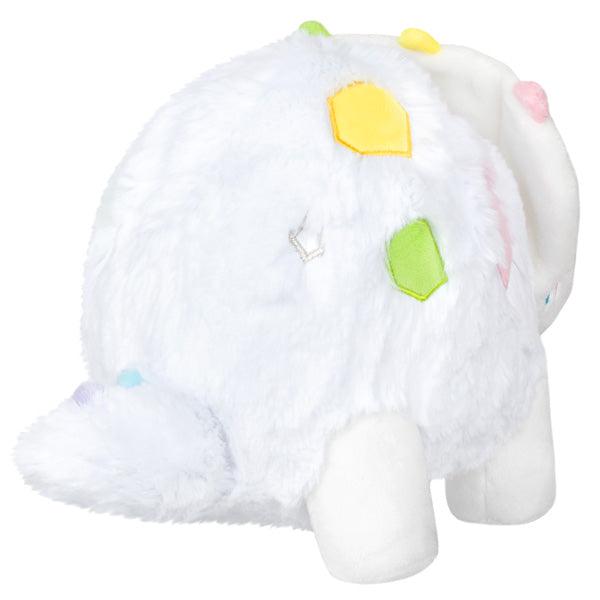 Back view of the plush. Shows that it has a white tail with small diffrerent colored spikes.