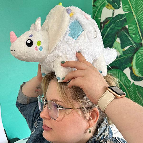 Scene of a woman holding the plush on top of her head.