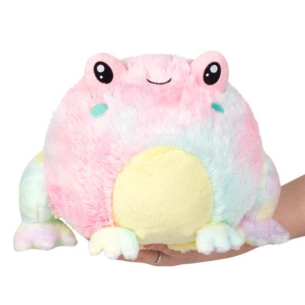 Image of the Mini Tie Dye Frog squishable. It is a mainly pink and blue pastel tie dye frog with a yellow belly.