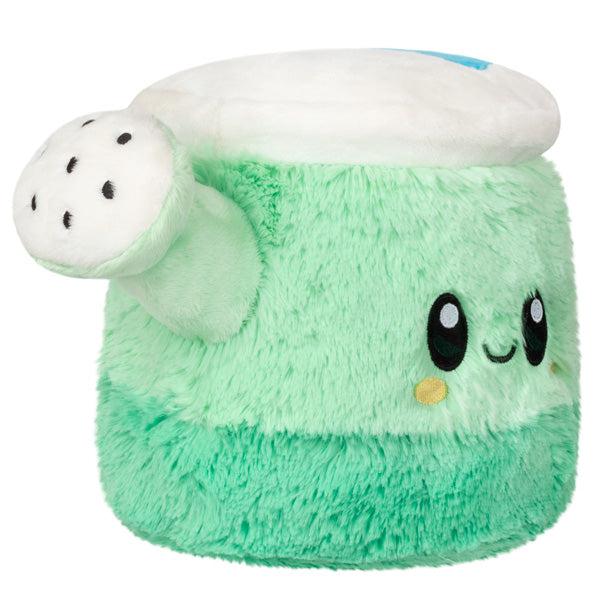 Side view of the plush. It has black spots on the spout like holes for the water to come out.